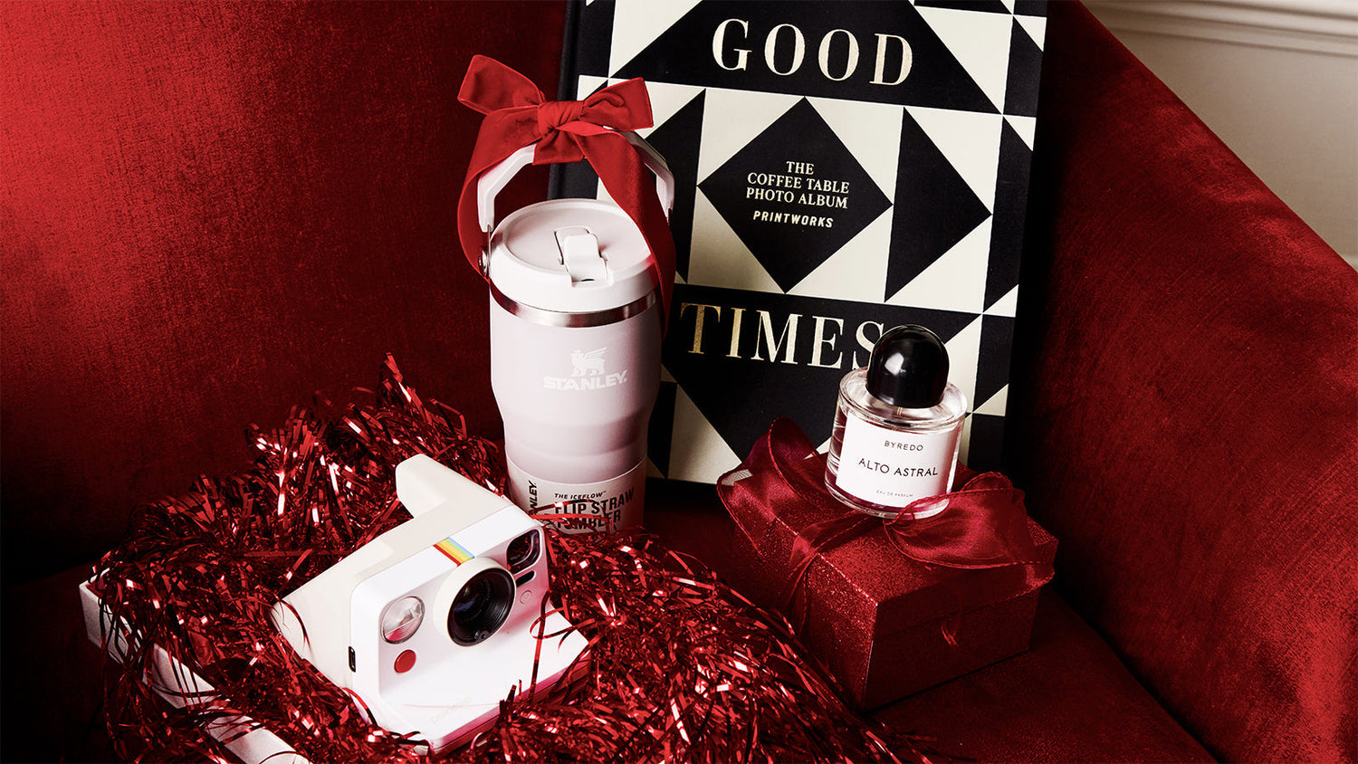 Small home accessory gifts placed on a red velvet material