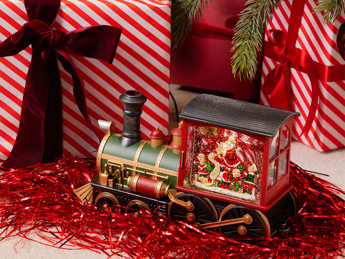 Christmas ornament next to  neatly wrapped presents